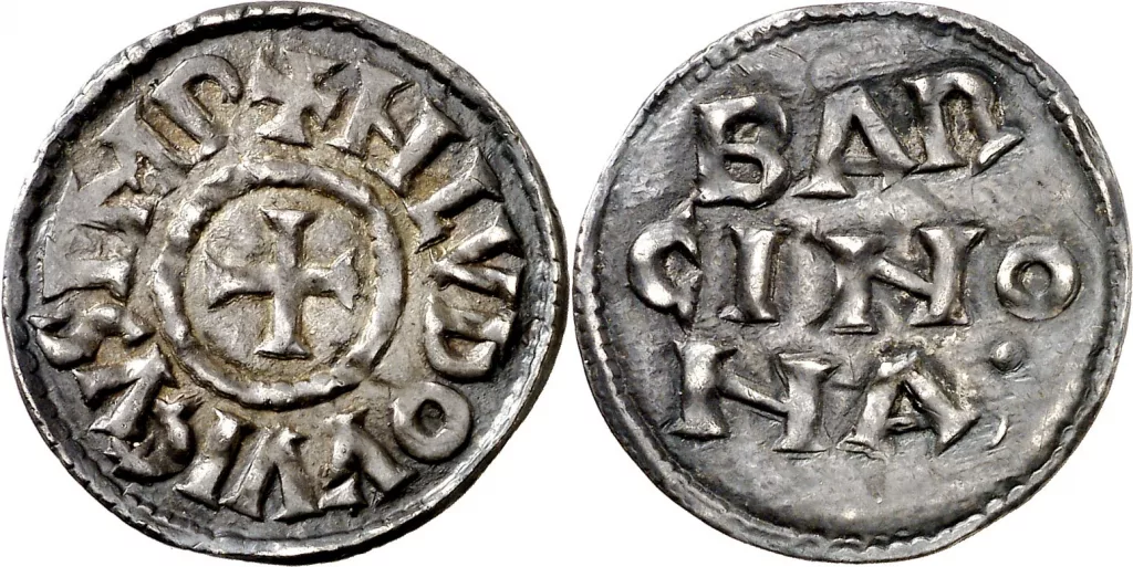 Dinero de plata carolingio en conmemoración de la toma de Barcelona: A: Cruz dentro de gráfila. + HLVDOVVICVS IMP R: BAR / CINO / NA•